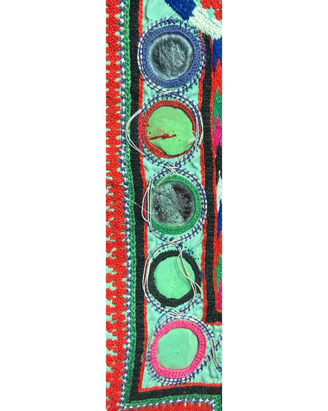 A custom stamped cuff bracelet by Redd Dott Jewelry, made with embroidered kaftan fabric and mirror details. A striking turquoise cuff bracelet with bold, folk-inspired texture.