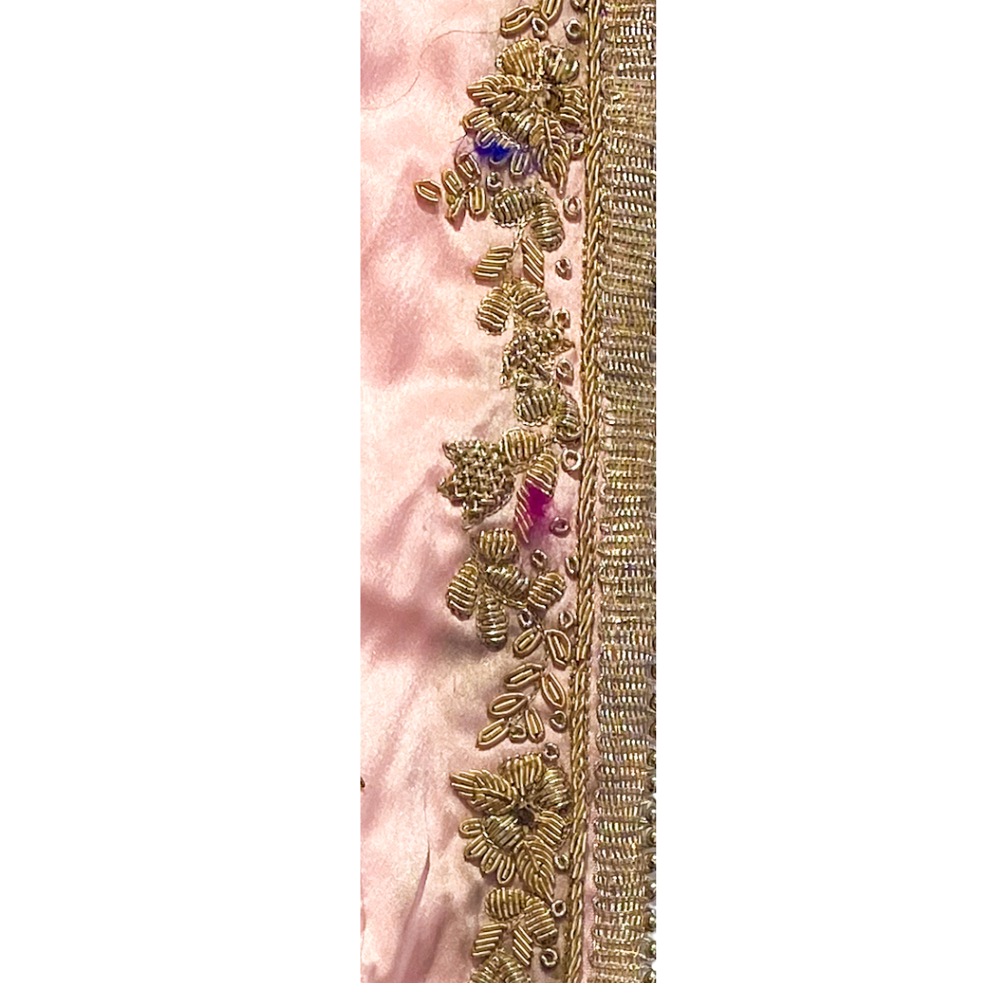 Gold statement bracelet with a blush pink satin base, embellished with intricate gold beadwork and floral details, custom-stamped and handmade by Redd Dott Jewelry.