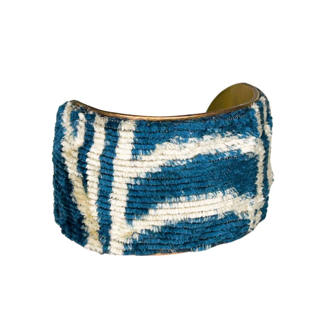 Kenji 2-inch statement cuff bracelet – raised indigo and ivory textile with bold geometric pattern wrapped around a wide brass base.