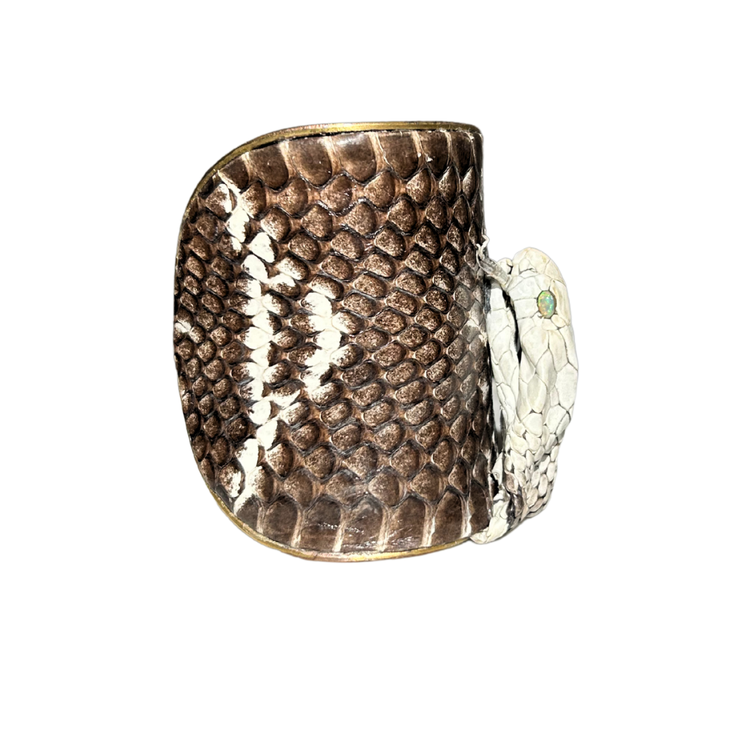Close-up of Brown King Cobra Snake Skin Statement Cuff Bracelet showing preserved cobra head, opal inlaid eyes, and natural texture of the gold cuff bracelet, handcrafted in Shreveport, LA by Redd Dott Jewelry.