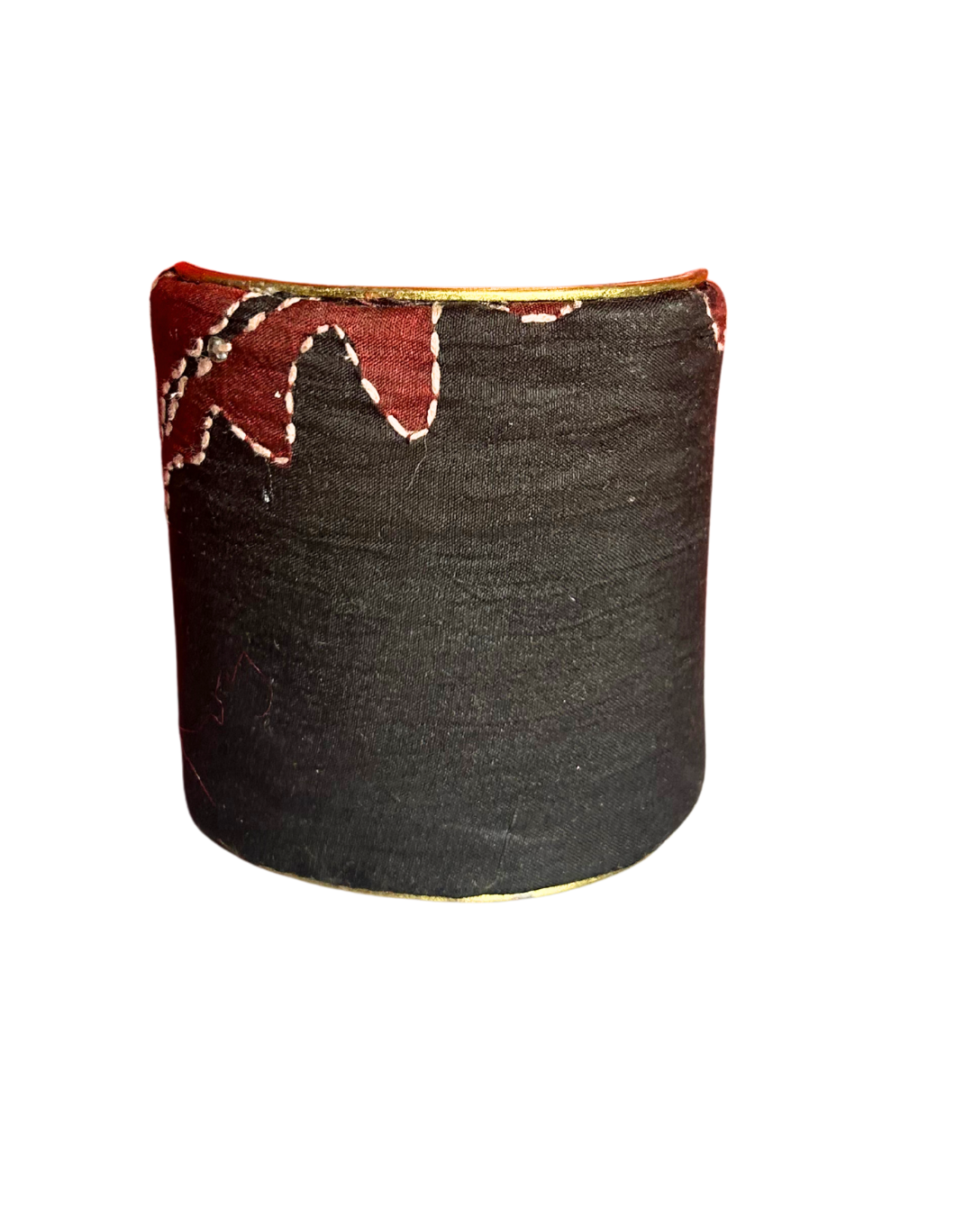 A handmade brass cuff bracelet from Redd Dott Jewelry, crafted and stamped in Shreveport, LA. Wrapped in black textile with red appliqué and white stitching along the top edge, creating a bold, minimalist vintage brass bracelet style.