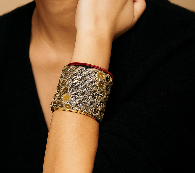 Woman wearing Athena Brass Cuff Bracelet featuring gold chevron embroidery and red trim, handcrafted in Shreveport, LA by Redd Dott Jewelry.