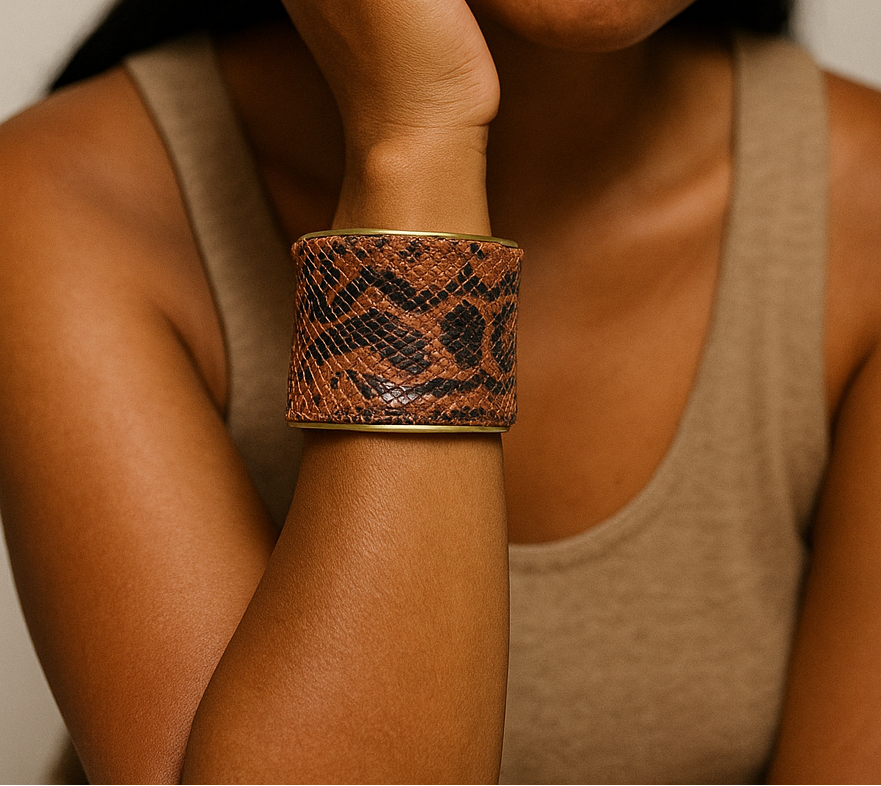 Model wearing anaconda snake skin cuff bracelet in its natural coloration and texture, paired with neutral tones; authentic statement jewelry from Redd Dott Ă— The Wild Ones.
