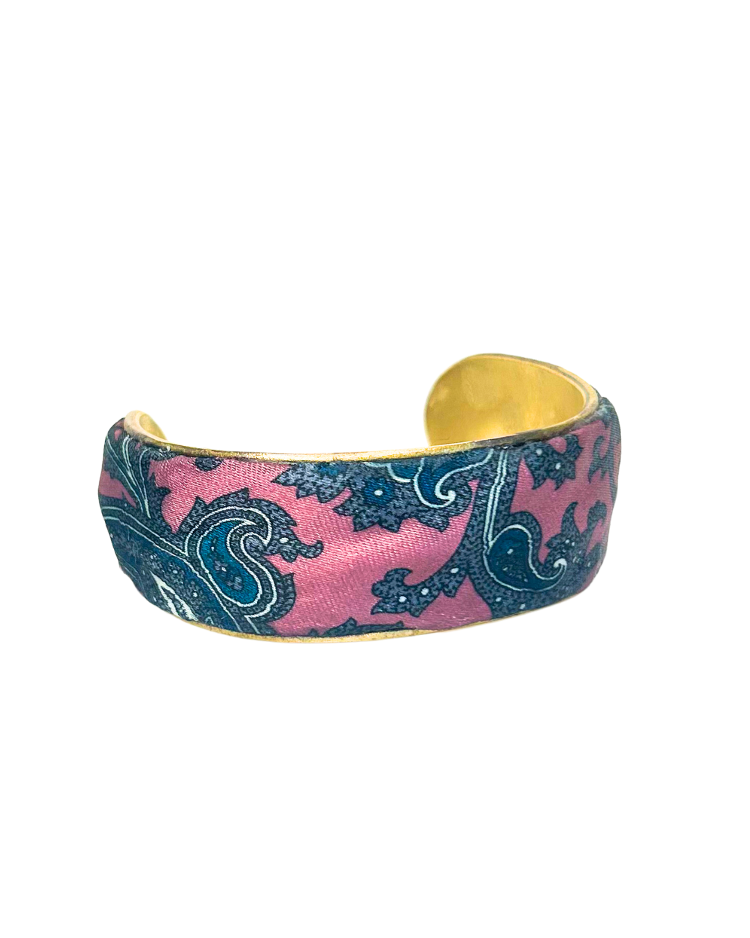 A brass cuff bracelet with a vintage-inspired pink and blue paisley fabric overlay, handcrafted by Redd Dott Jewelry. The intricate swirling patterns and warm gold brass base create a timeless vintage bracelet look with an artistic, bohemian flair.