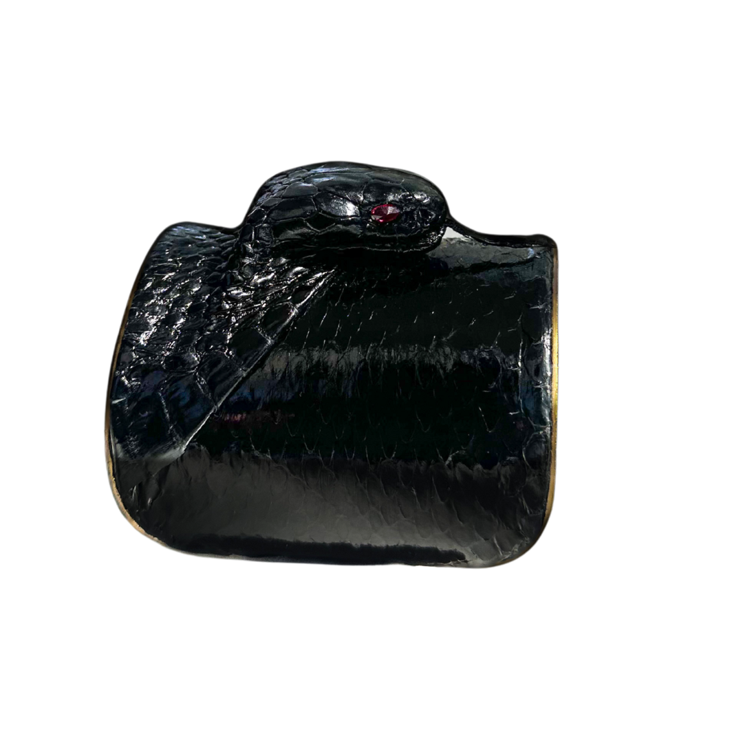 3-inch wide gold cuff bracelet featuring genuine black snake skin with sculpted cobra head and ruby gemstone eyes; handcrafted statement jewelry by Redd Dott.