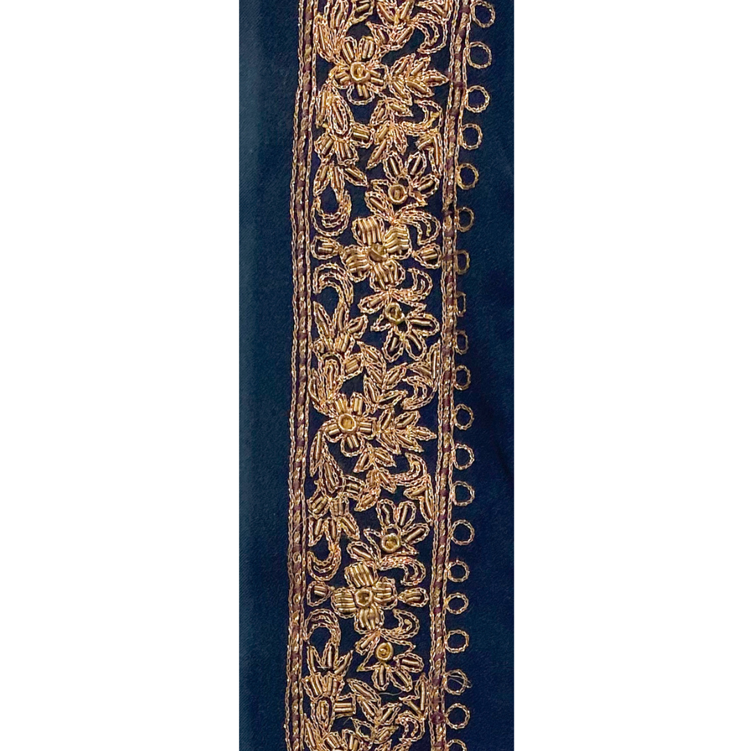 Gold statement bracelet with intricate floral embroidery on a navy fabric base, custom-stamped and handmade by Redd Dott Jewelry.