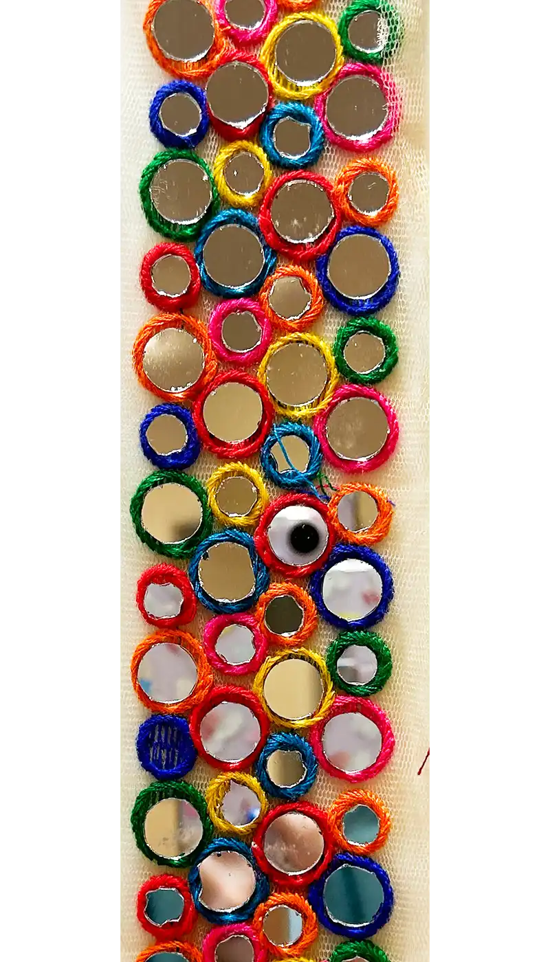 Close-up image of the Customizable Xenia Mirrored Rainbow Inspirational Cuff Bracelet, featuring an intricate design of colorful circular embroidery in vibrant rainbow hues with embedded reflective mirrors, creating a playful and dynamic accessory.