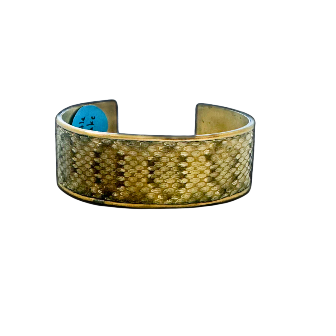 1-inch brass cuff bracelet with genuine rattlesnake skin in golden-beige and brown tones, featuring natural texture and pattern; rustic men’s jewelry by Redd Dott.