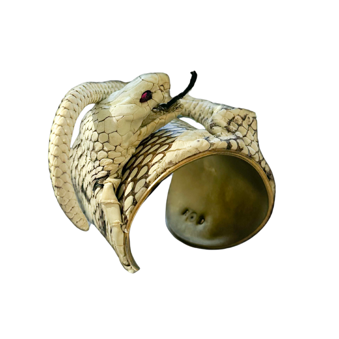 3-inch brass cuff bracelet handcrafted from genuine king cobra skin with serpent head and tail, ruby gemstone eyes, and open cuff design; statement jewelry by Redd Dott.