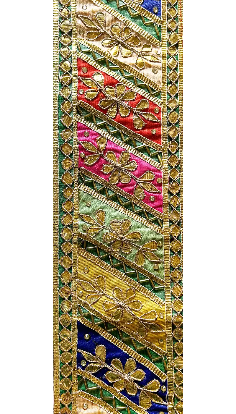 Close-up of floral embroidered fabric with gold, green, red, and turquoise threads used for the Alexia Custom Quote Cuff Bracelet, handcrafted in Shreveport, LA by Redd Dott Jewelry.
