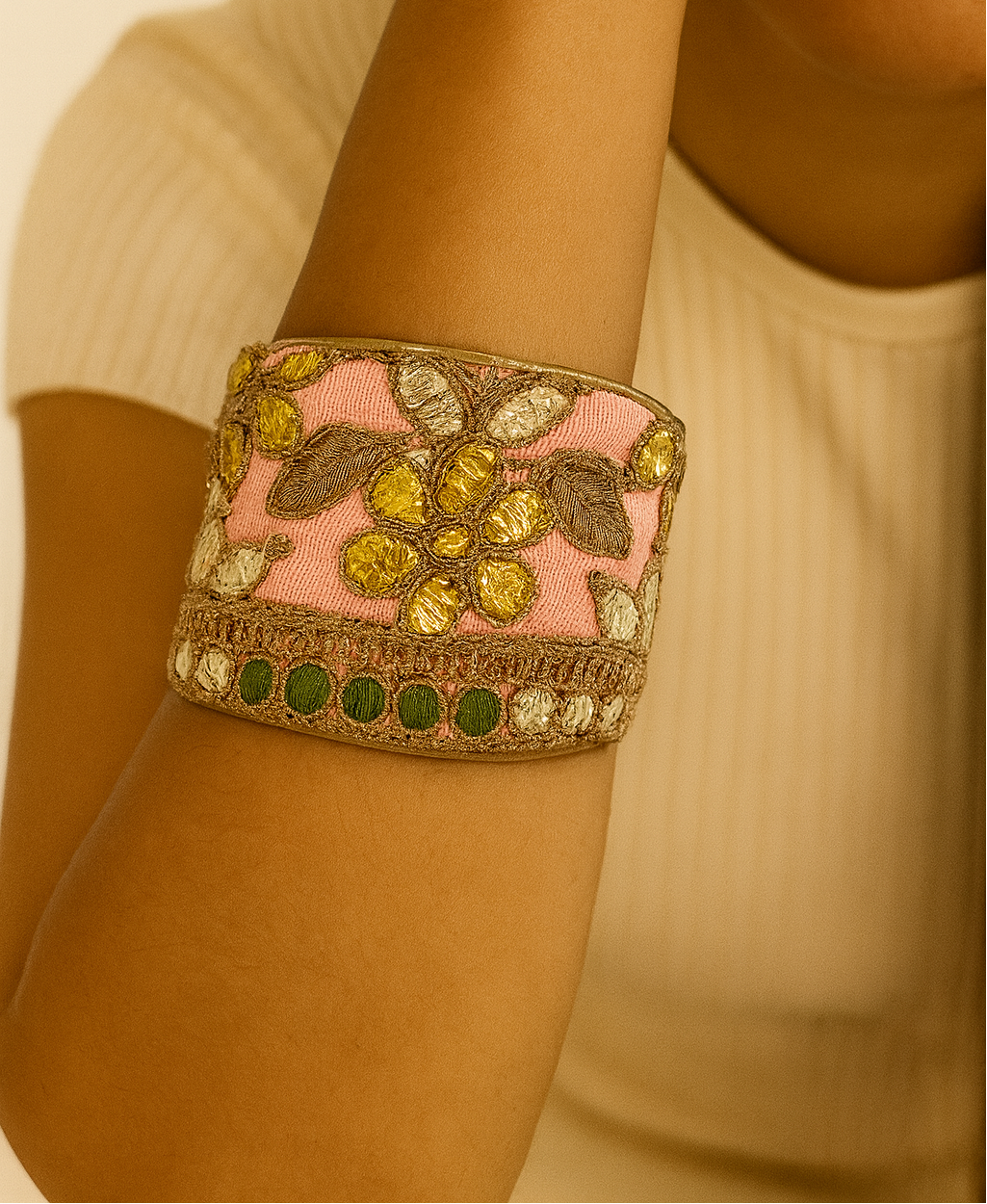 Woman wearing the Amelia Inspirational Cuff Bracelet with blush pink fabric, gold embroidery, and green accents on brass, handcrafted in Shreveport, LA by Redd Dott Jewelry.