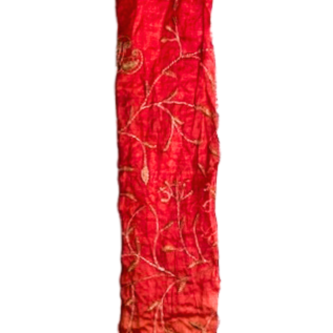 A nature-inspired jewelry piece by Redd Dott Jewelry, featuring golden vine embroidery on a rich crimson background.