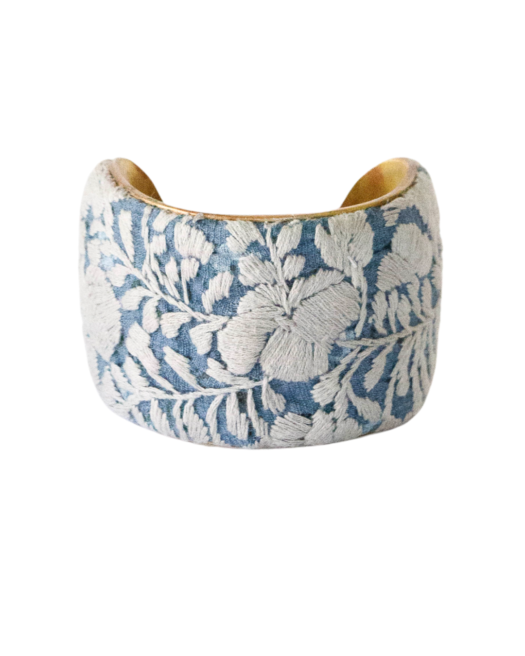 Two-inch Cielo Gris cuff bracelet featuring delicate ivory embroidery on light blue fabric over hand-shaped brass.