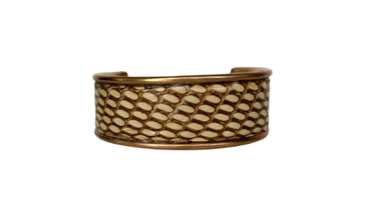 A Redd Dott Jewelry cuff made with genuine Eastern Brown snake skin, designed with nature-inspired jewelry elements. The intricate patterns and natural texture of the snake skin make it a bold and elegant accessory