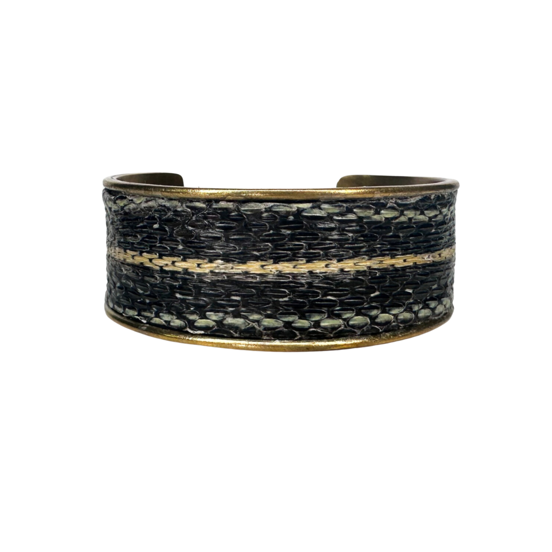 A handcrafted Redd Dott Jewelry cuff made from genuine Garter Snake skin, showcasing the delicate scale patterns and textures of nature-inspired jewelry. A bold yet elegant statement piece for lovers of organic and earthy accessories.