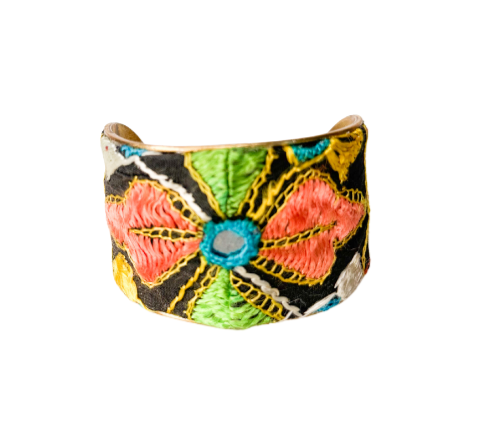 Hand-stamped cuff bracelet with vibrant, Indian-inspired floral embroidery design in bold colors including pink, green, and blue.