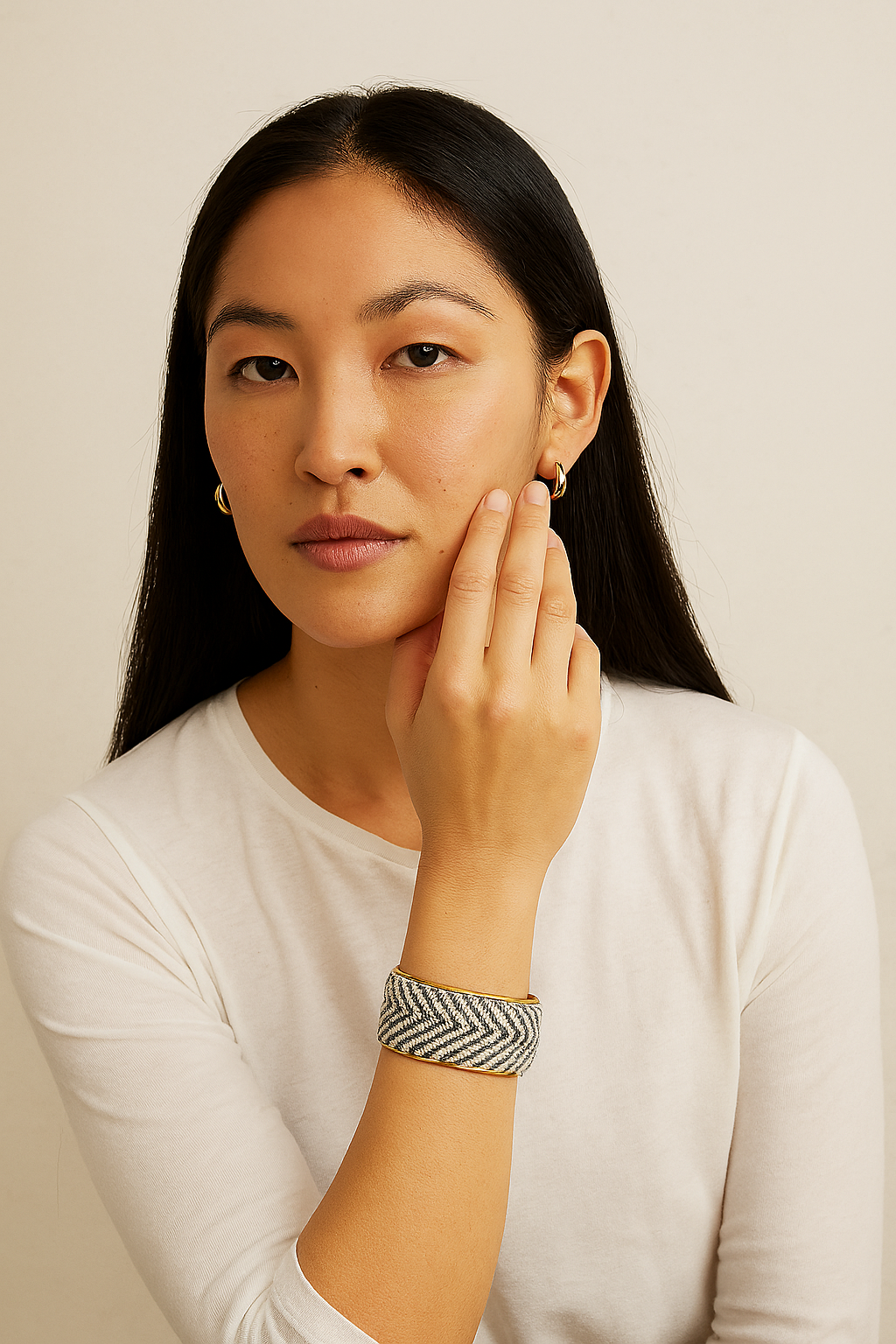 A 1-inch wide brass cuff bracelet wrapped in gray and cream chevron herringbone fabric, featuring an open-back adjustable design. This one of a kind jewelry piece blends sleek metal with textured textile and contains a hidden hand-stamped surprise inspirational quote inside.