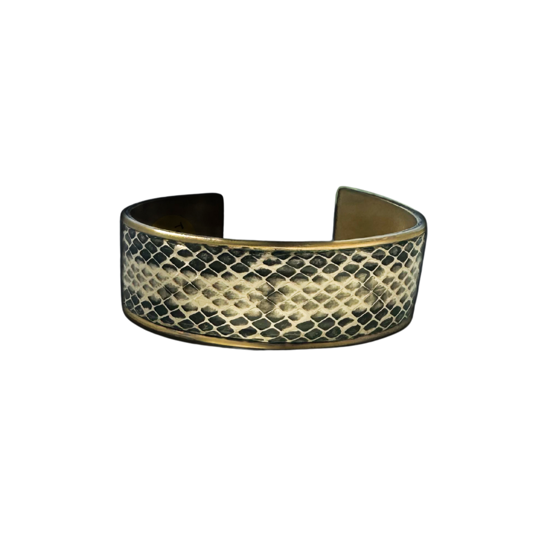 1-inch gold cuff bracelet featuring genuine Texas rat snake skin in ivory and charcoal tones with diamond scale texture and polished brass edge; handcrafted men’s jewelry by Redd Dott.