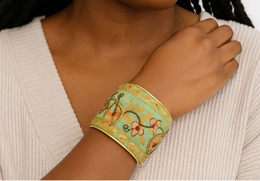Woman wearing the Ambrose Brass Cuff Bracelet, a mint green and gold embroidered jewelry cuff with floral detailing, artisan handmade jewelry handcrafted in Shreveport, LA by Redd Dott Jewelry.