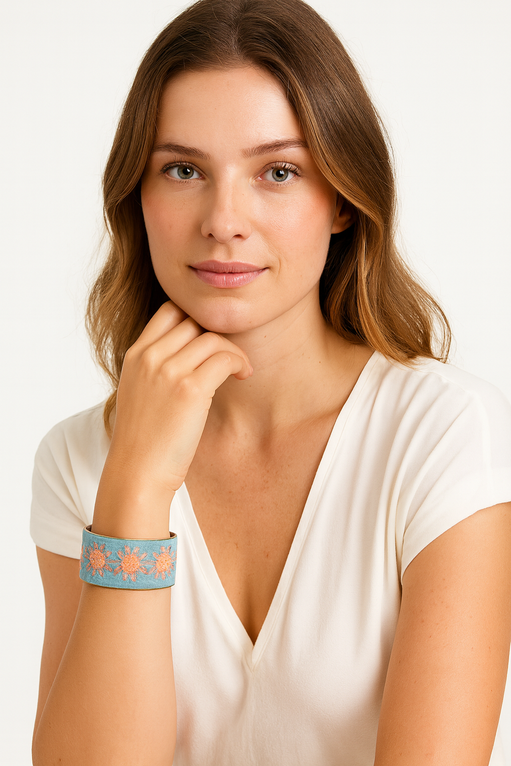 Redd Dott Lucinne 1-inch cuff bracelet in soft sky blue textile with embroidered peach-toned floral motifs, framed in brass for a fresh and delicate design.
