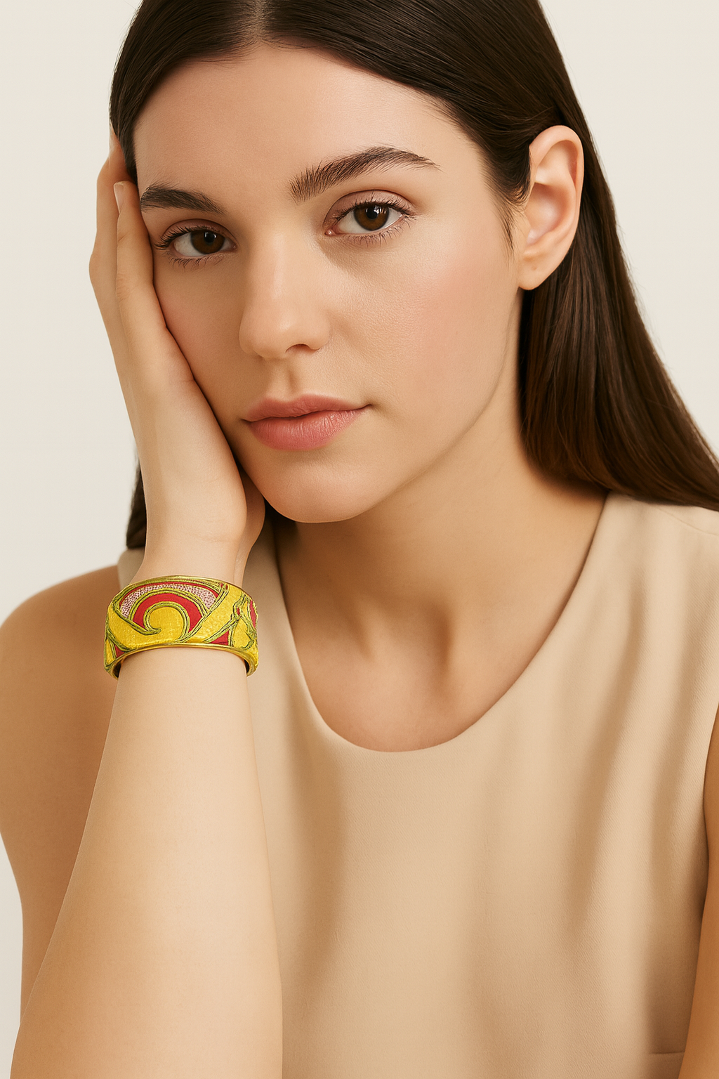 Redd Dott Lyra 1-inch cuff bracelet with bold yellow and magenta embroidered swirls on a shimmering gold base, framed in brass for a radiant, modern statement.