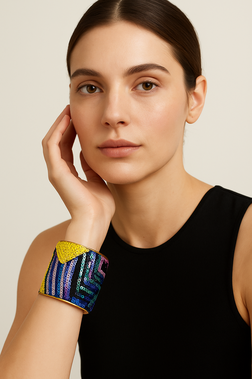 Front view of the Redd Dott Mardi On 3-inch cuff bracelet, adorned with shimmering multicolored sequins in bold geometric patterns and finished with a golden brass frame, designed for a festive, sparkling Mardi Gras statement.