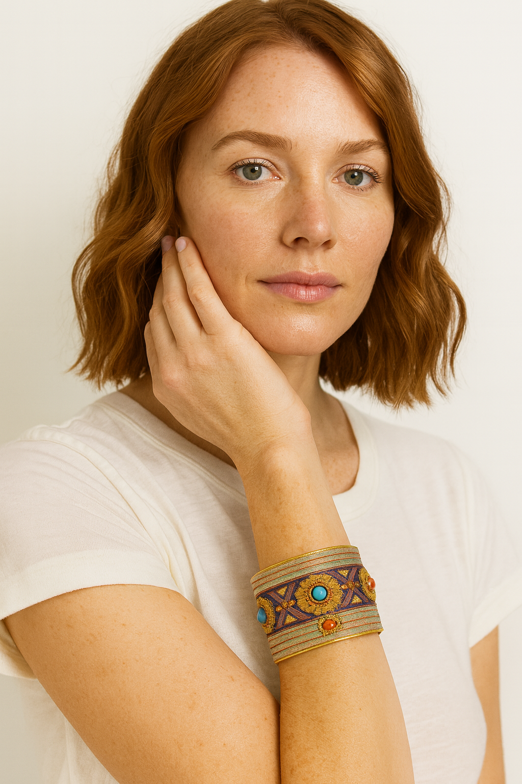 Model wearing the Redd Dott Marla 2-inch cuff bracelet, embroidered with intricate gold and violet patterns accented by turquoise and coral beads, framed in gold for a refined yet bold statement.
