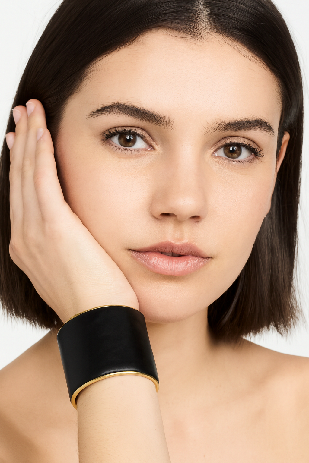 Model wearing the Redd Dott Marvel 2-inch cuff bracelet, crafted from smooth black leather with a polished gold frame, offering a bold yet timeless statement of modern elegance.