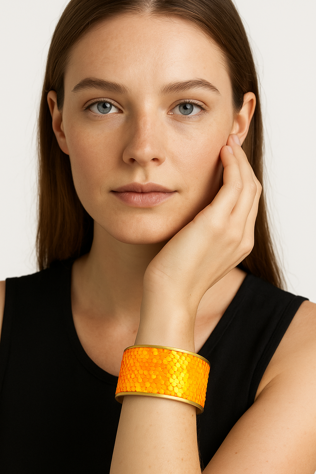 Model wearing the Redd Dott My Mardi Krewe 2-inch cuff bracelet, designed with vibrant orange sequins that shimmer like scales, framed in gold trim for a bold, festive statement.