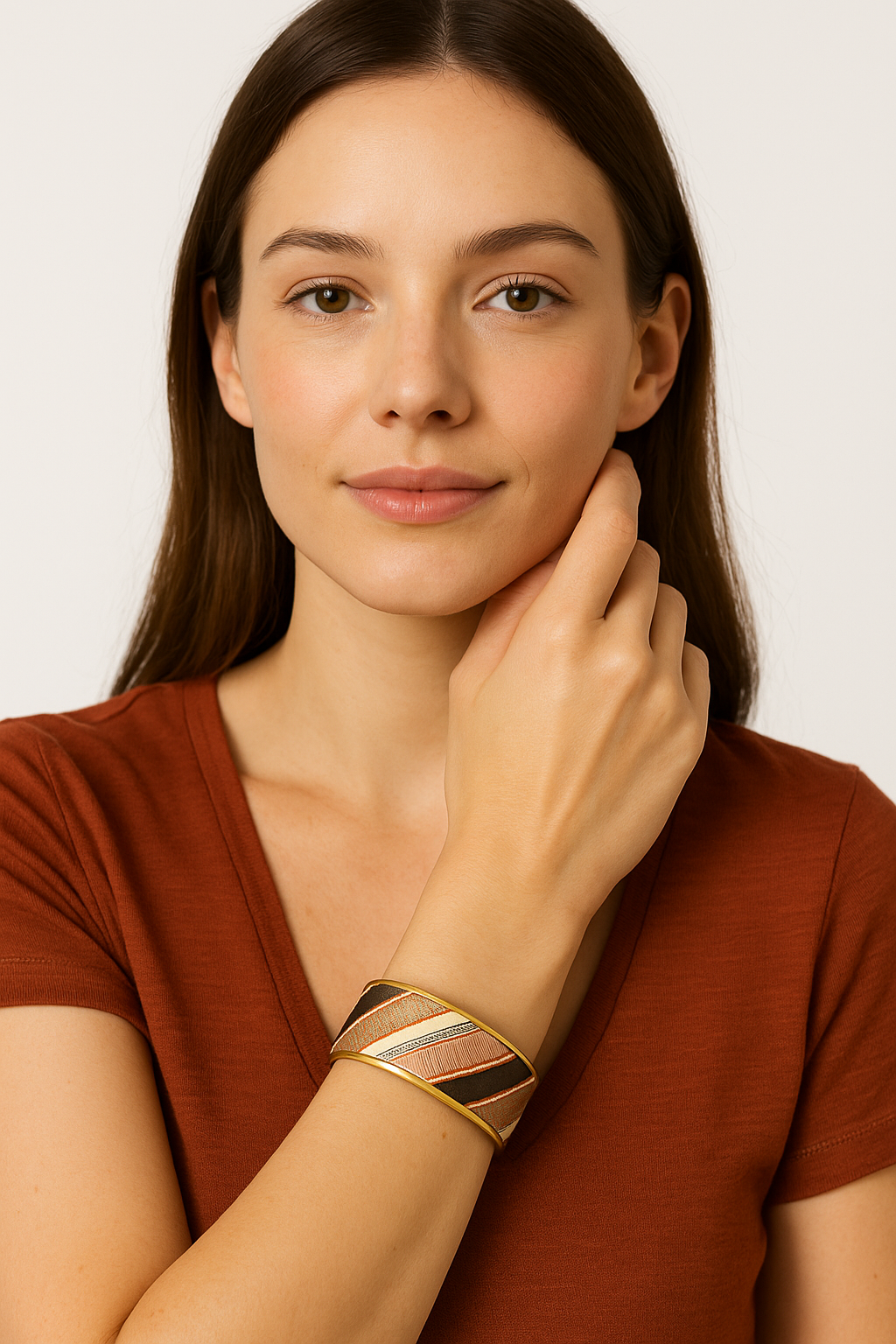 Model wearing the Redd Dott Nayeli 1-inch cuff bracelet, designed with bold diagonal stripes in warm copper, silver, and deep brown tones, framed in gold for a sleek, modern elegance.