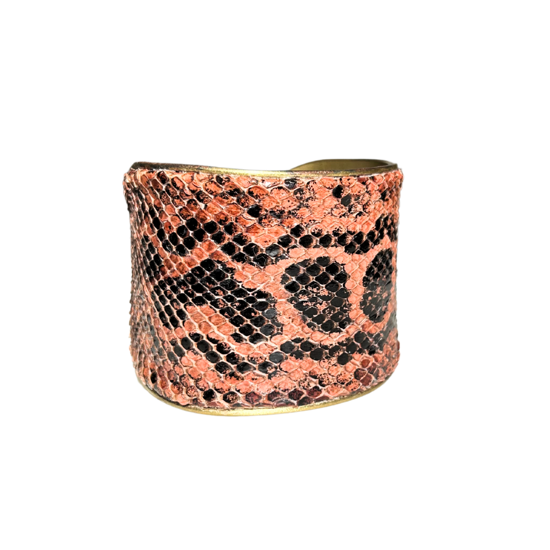 A handcrafted nature inspired jewelry cuff bracelet by Redd Dott Jewelry, made with genuine anaconda skin in rose terracotta and black tones over a warm brass base. Bold, textured, and deeply exotic.