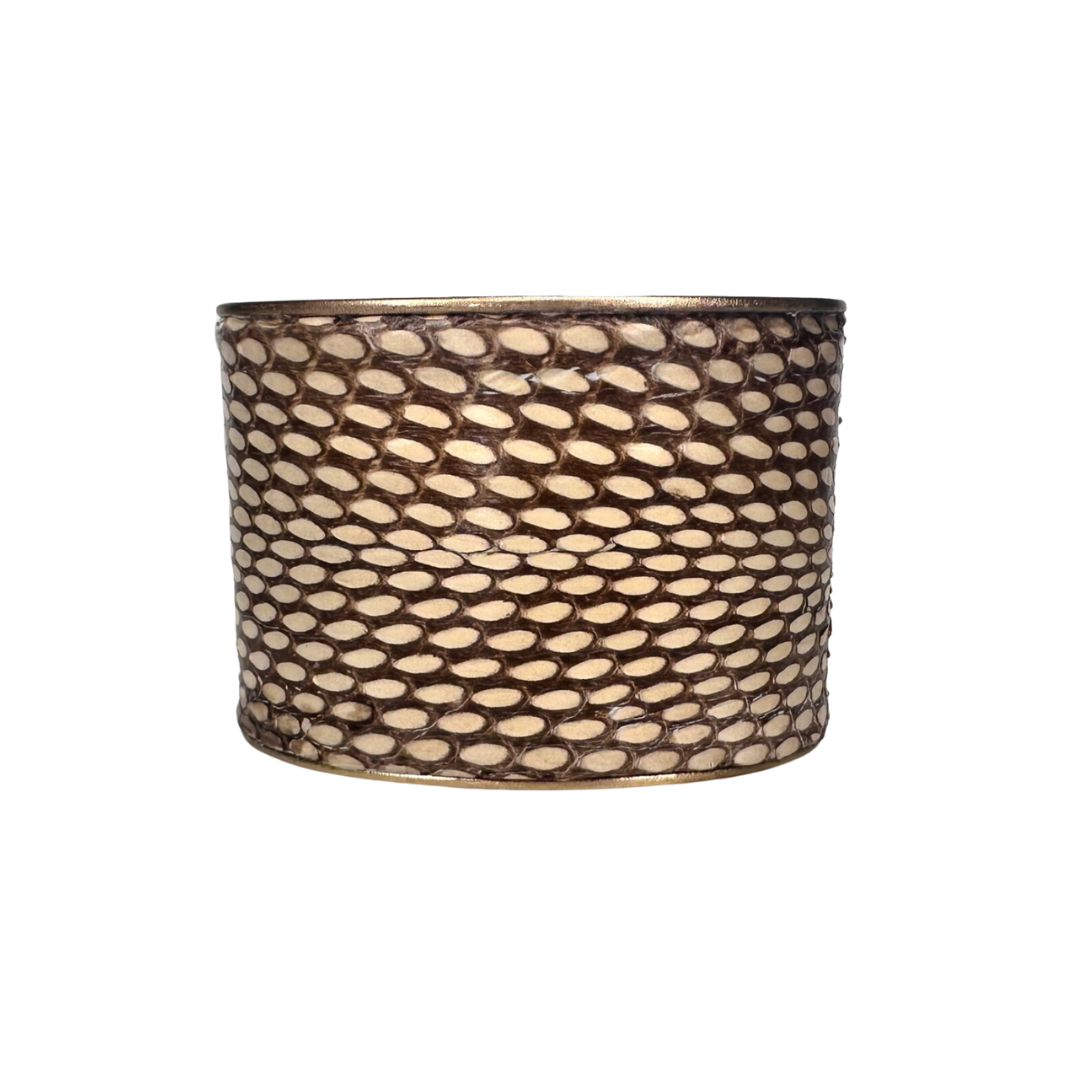 A Redd Dott Jewelry cuff made with genuine Eastern Brown snake skin, designed with nature-inspired jewelry elements. The intricate patterns and natural texture of the snake skin make it a bold and elegant accessory