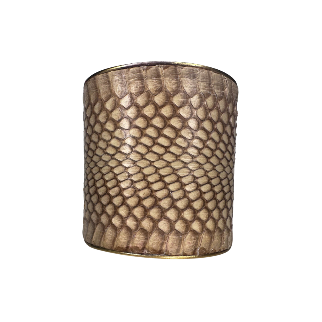 A Redd Dott Jewelry cuff made with genuine Eastern Brown snake skin, designed with nature-inspired jewelry elements. The intricate patterns and natural texture of the snake skin make it a bold and elegant accessory