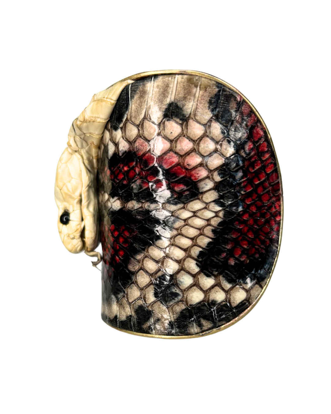 A striking Redd Dott Jewelry cuff featuring the preserved head of a genuine King Cobra snake skin. This unique piece of nature-inspired jewelry showcases the snake’s intricate scales and powerful design, making it a bold statement accessory.