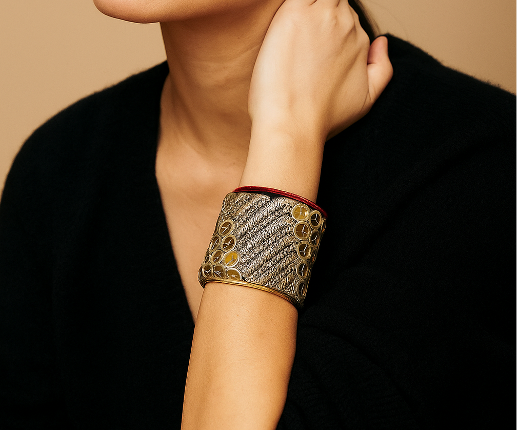 Woman wearing Athena Brass Cuff Bracelet featuring gold chevron embroidery and red trim, handcrafted in Shreveport, LA by Redd Dott Jewelry.